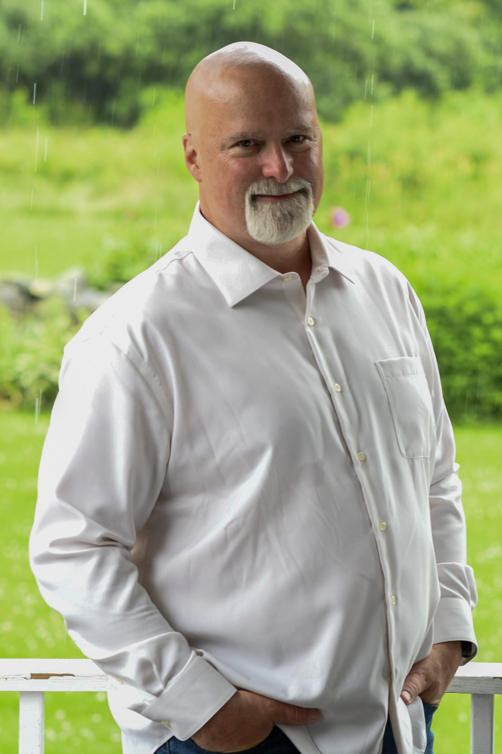 Image of Tim Young standing outdoors wearing a white button-down shirt.