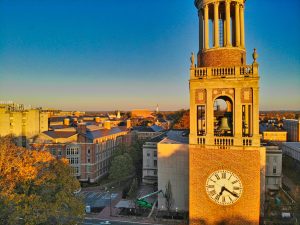 This picture shows a skyline of Chapel Hill, North Carolina. In the foreground is the bell tower for the University of North Carolina at Chapel Hill.