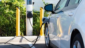 An electric vehicle is plugged in at a charging station.