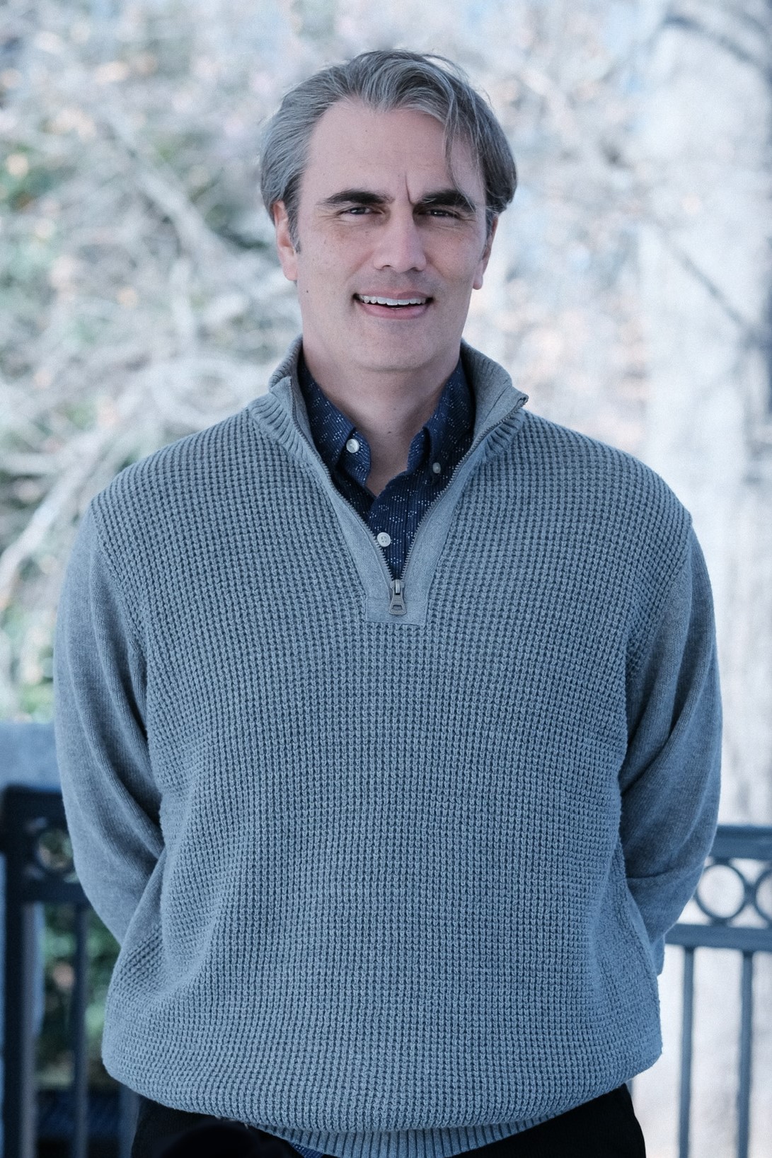 Picture of Jeremy Wilhelm wearing a quarter-zip sweater while standing outdoors.