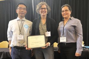 Picture of attendees at the TRB Conference on Innovations in Travel Analysis and Planning accepting the 'Best Panel Presentation" award on behalf of a presentation that was coauthored by RSG Director Jon Slason and Adam Argo of the Oregon Department of Transportation. Pictured (from left to right): Xuesong (Simon) Zhou, Tara Weidner, and Rosella Picado.